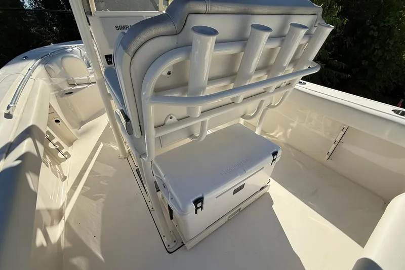 Slide: The Image of 2024 Key West 244 Center Console boat interior with rod holders and cooler. - 9