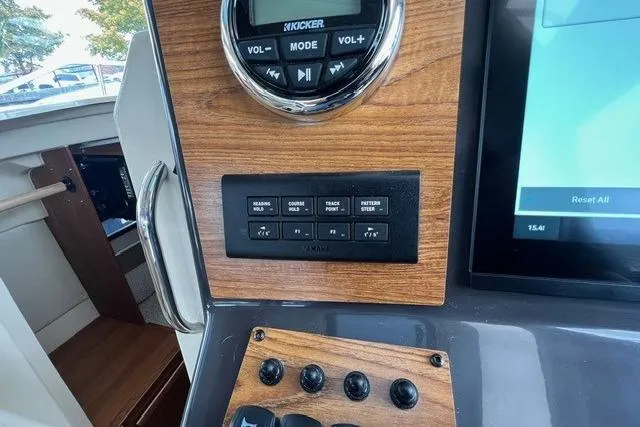 Slide: The Image of Control panel of 2025 Ranger Tugs R-25 Luxury Edition with wood finish and digital display. - 15
