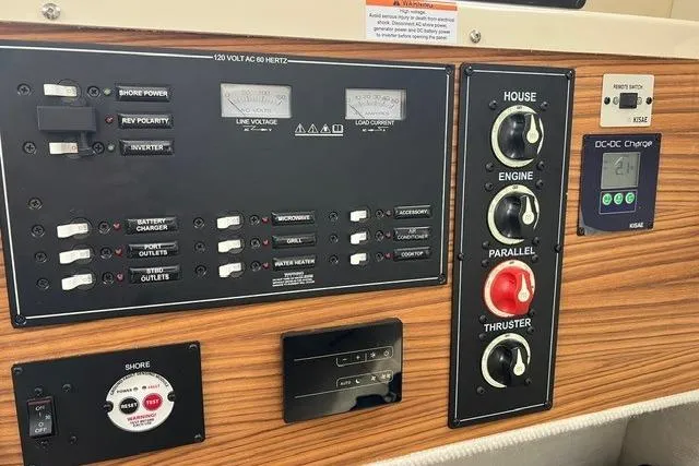 Slide: The Image of Control panel of 2025 Ranger Tugs R-25 Luxury Edition with various switches and gauges. - 21