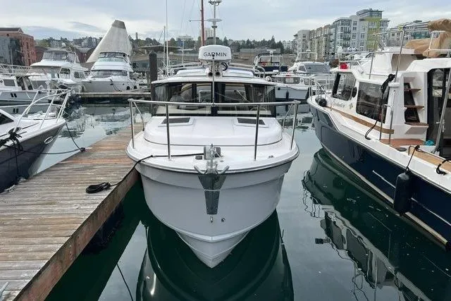 Slide: The Image of 2025 Ranger Tugs R-25 Luxury Edition docked at marina, front view. - 3