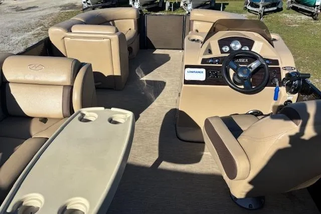 Slide: The Image of Interior of a 2020 Harris Cruiser 210 boat with beige seating and steering console. - 10