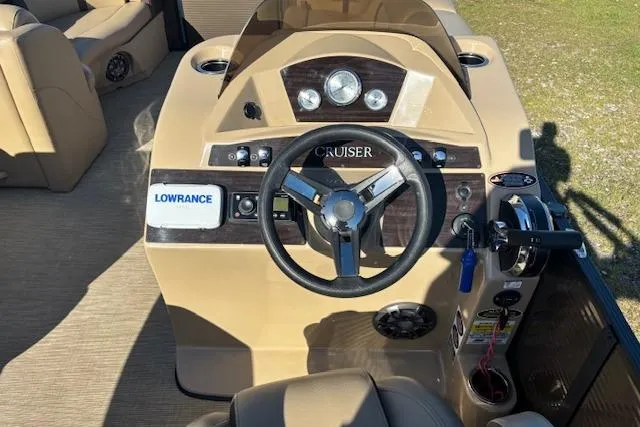 Slide: The Image of 2020 Harris Cruiser 210 boat dashboard with steering wheel and Lowrance navigation system. - 11