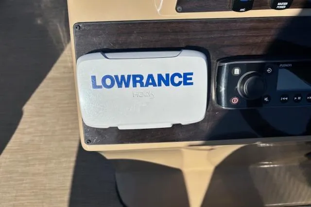 Slide: The Image of Control panel of 2020 Harris Cruiser 210 with Lowrance and Fusion devices. - 12
