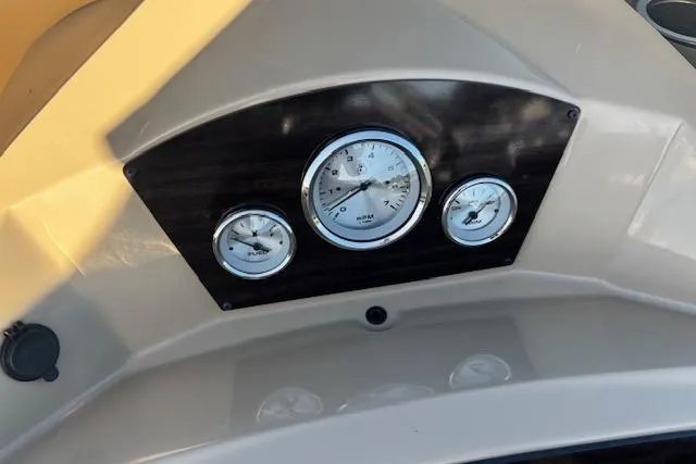 Slide: The Image of Dashboard of 2020 Harris Cruiser 210 boat with three gauges. - 14