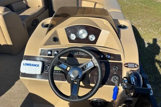 Slide: The Image of 2020 Harris Cruiser 210 boat dashboard with steering wheel and Lowrance navigation system. - 15