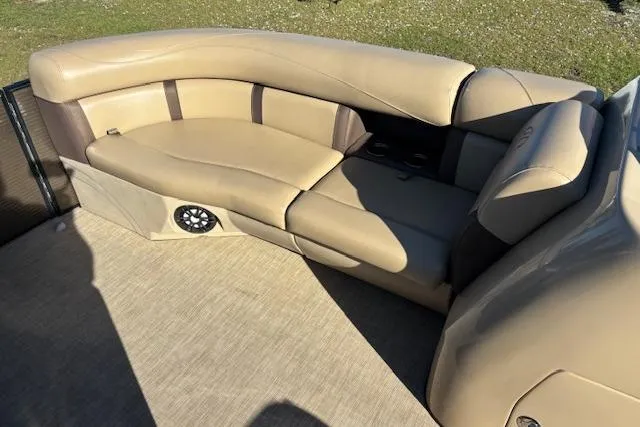 Slide: The Image of 2020 Harris Cruiser 210 boat interior with beige seating and speaker. - 19