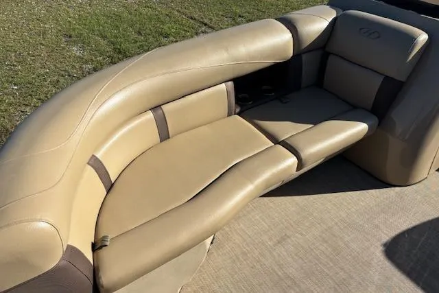 Slide: The Image of 2020 Harris Cruiser 210 boat with beige leather seating and brown accents. - 20