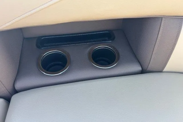 Slide: The Image of Cup holders in 2020 Harris Cruiser 210 boat with beige and brown interior. - 23