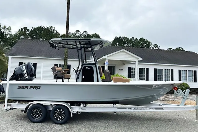 The Image of 2026 Sea Pro 230 Bay boat on trailer, parked in front of a house. - 1