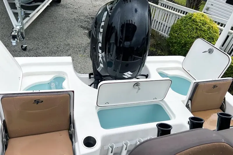 Slide: The Image of 2026 Sea Pro 230 Bay boat with Suzuki engine and livewells, rear seating view. - 10