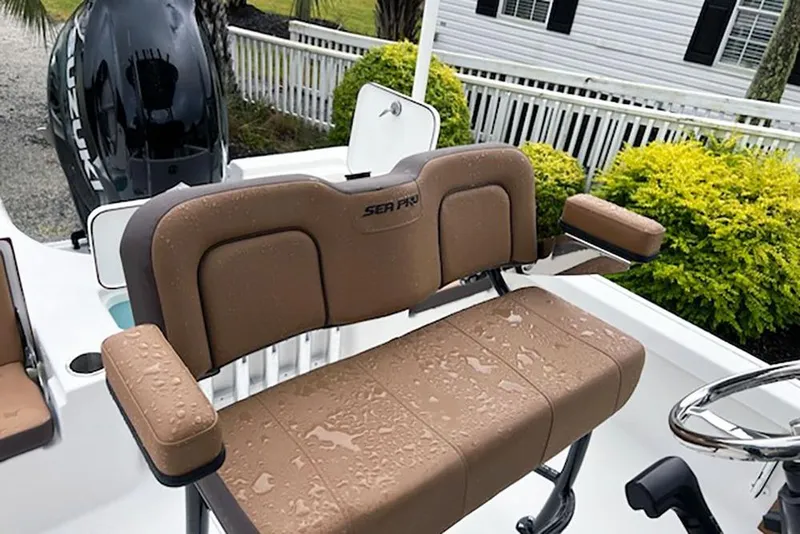 Slide: The Image of 2026 Sea Pro 230 Bay boat interior with wet tan seating and steering wheel. - 11