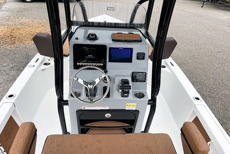 Slide: The Image of 2026 Sea Pro 230 Bay boat console with steering wheel and navigation controls. - 12