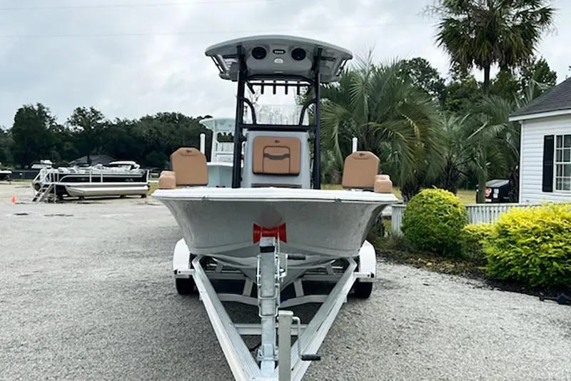 Slide: The Image of 2026 Sea Pro 230 Bay boat on trailer, parked outdoors near palm trees. - 4