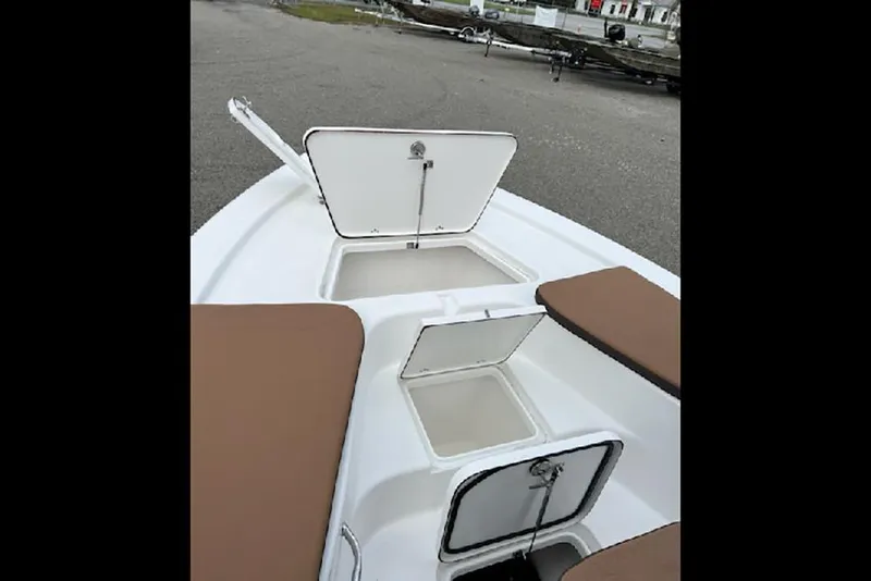 Slide: The Image of 2026 Sea Pro 230 Bay boat storage compartments with open hatches, showcasing interior space. - 6