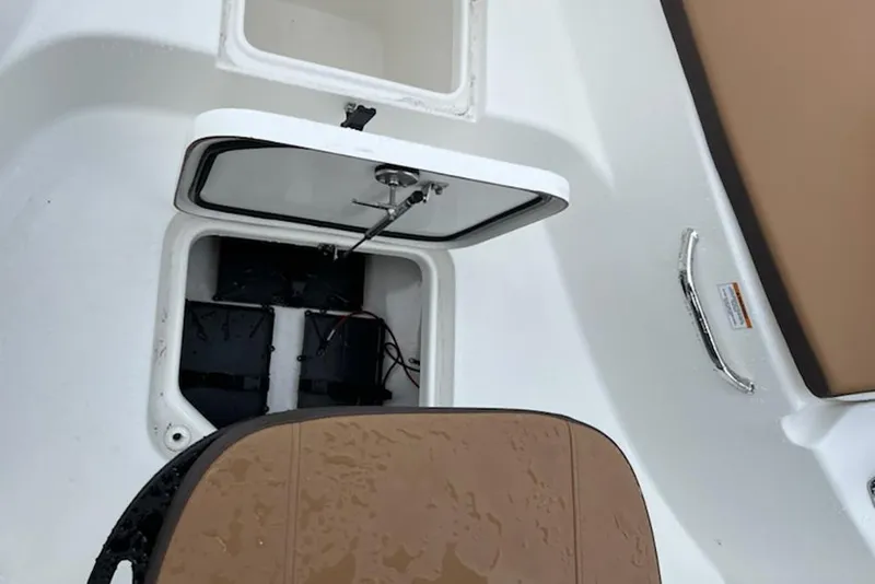 Slide: The Image of Open storage compartment on 2026 Sea Pro 230 Bay boat, showing interior details. - 7