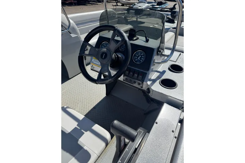 Slide: The Image of 2014 SeaArk Easy 200 boat dashboard with steering wheel and gauges. - 4