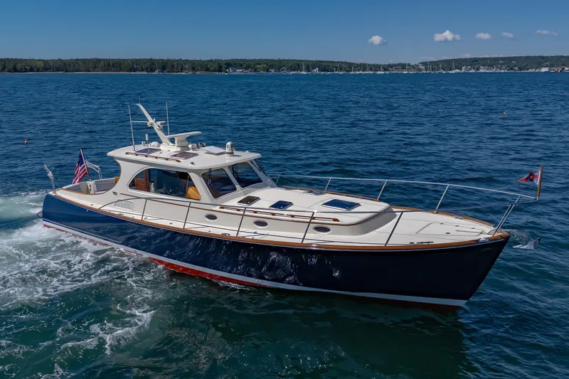 Slide: The Image of 2009 Hinckley Talaria 44 MY yacht cruising on open water under clear skies. - 10