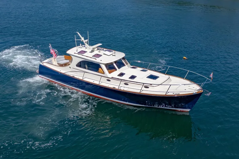 Slide: The Image of 2009 Hinckley Talaria 44 MY yacht cruising on clear blue water. - 11