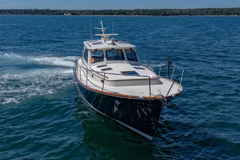 Slide: The Image of 2009 Hinckley Talaria 44 MY cruising on open water, showcasing elegant design and craftsmanship. - 12