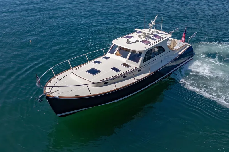 Slide: The Image of 2009 Hinckley Talaria 44 MY yacht cruising on clear blue water. - 14