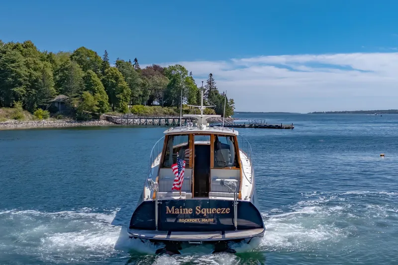 Slide: The Image of 2009 Hinckley Talaria 44 MY yacht cruising in scenic coastal waters. - 15