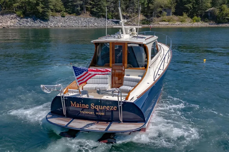Slide: The Image of 2009 Hinckley Talaria 44 MY yacht, "Maine Squeeze," cruising in scenic waters. - 16