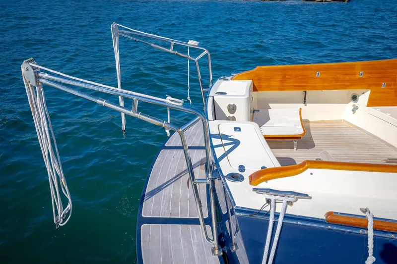 Slide: The Image of Hinckley Talaria 44 MY 2009 yacht deck with wooden accents and stainless steel railings. - 18