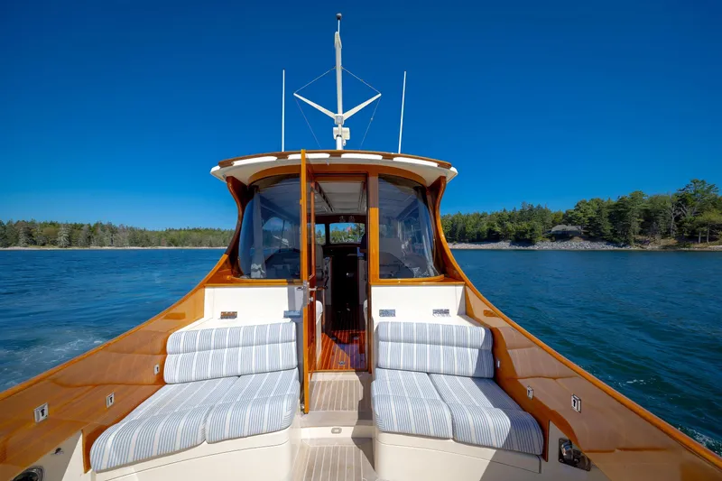 Slide: The Image of 2009 Hinckley Talaria 44 MY yacht cruising on a serene lake with clear blue skies. - 22