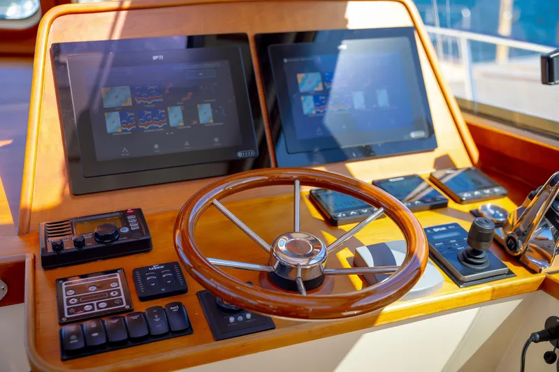 Slide: The Image of Helm of 2009 Hinckley Talaria 44 MY with modern navigation displays and controls. - 38