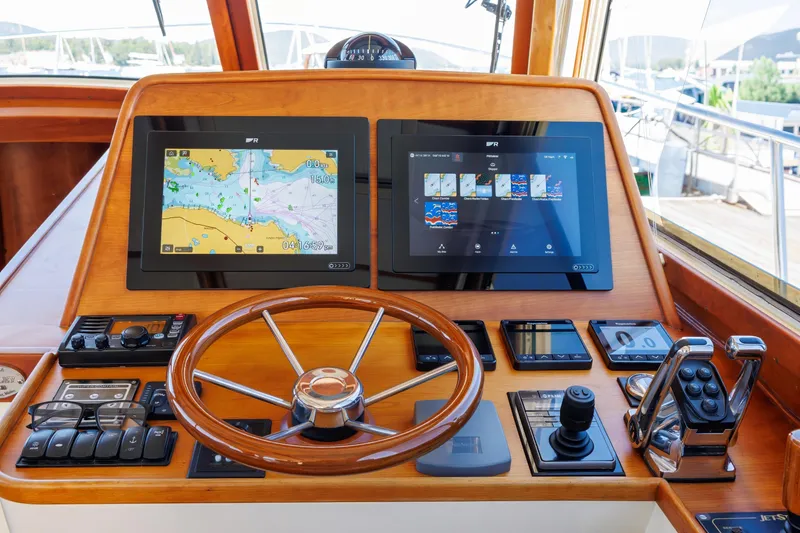 Slide: The Image of Helm of 2009 Hinckley Talaria 44 MY with navigation screens and controls. - 39