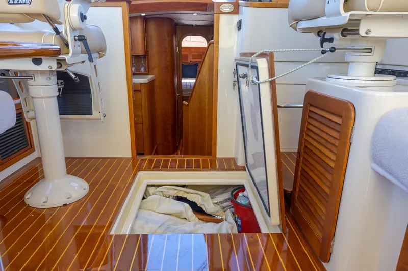 Slide: The Image of Interior of 2009 Hinckley Talaria 44 MY yacht with wooden flooring and storage compartment. - 44