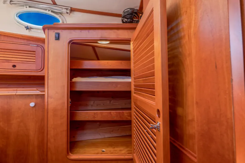 Slide: The Image of Wooden interior storage on 2009 Hinckley Talaria 44 MY yacht with open shelves and porthole. - 61