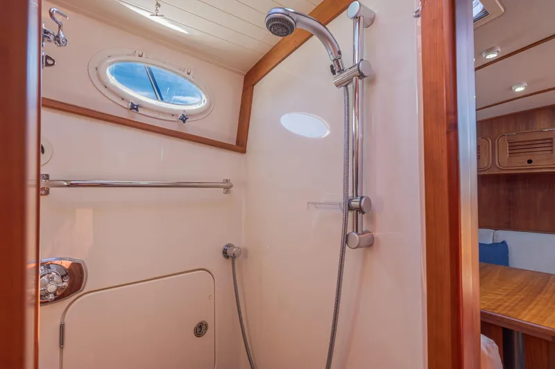 Slide: The Image of Luxurious shower area in 2009 Hinckley Talaria 44 MY yacht with wooden accents. - 65