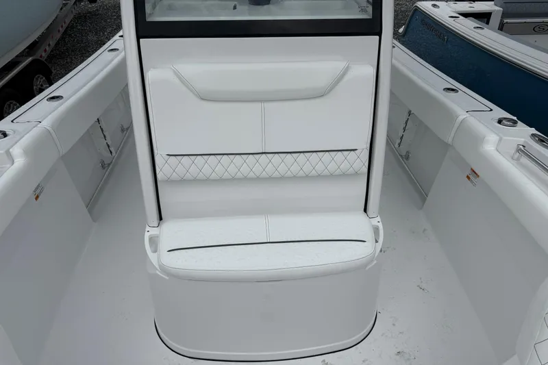 Slide: The Image of 2026 Sportsman Heritage 231 Center Console boat interior with white seating and sleek design. - 10