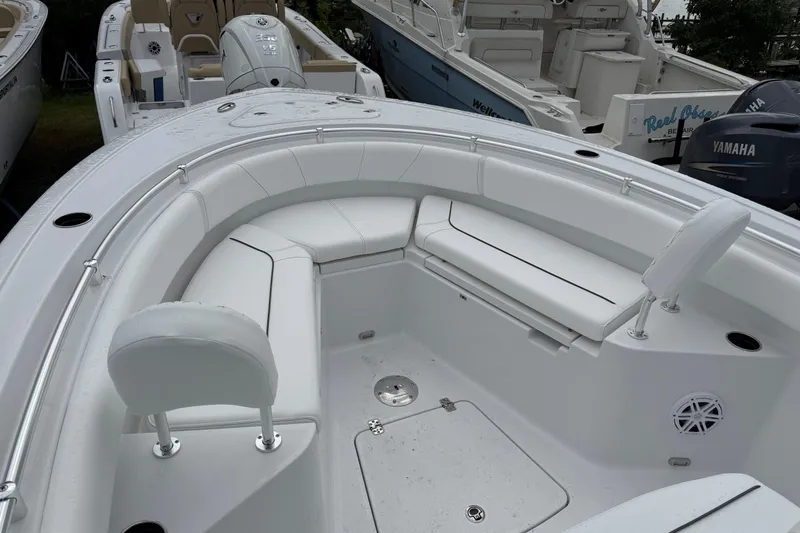 Slide: The Image of 2026 Sportsman Heritage 231 Center Console boat with white seating and spacious deck. - 12