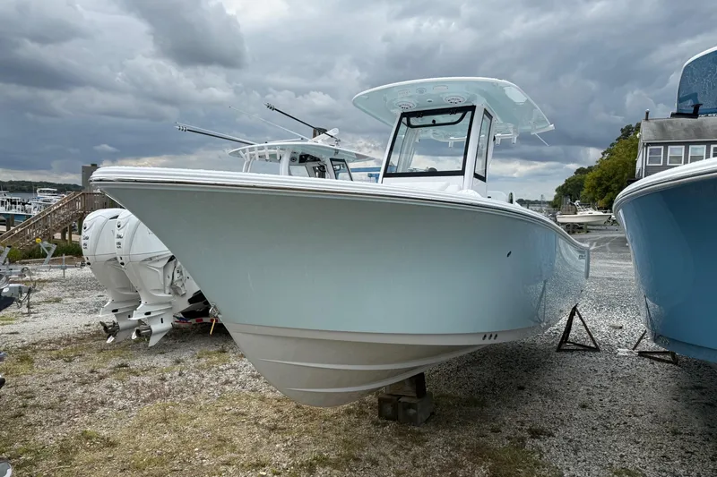 Slide: The Image of 2026 Sportsman Heritage 231 Center Console boat on display under cloudy skies. - 3
