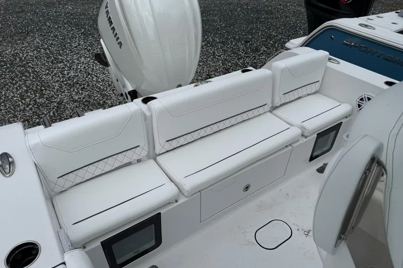 Slide: The Image of 2026 Sportsman Heritage 231 Center Console boat with white cushioned seating and Yamaha engine. - 4