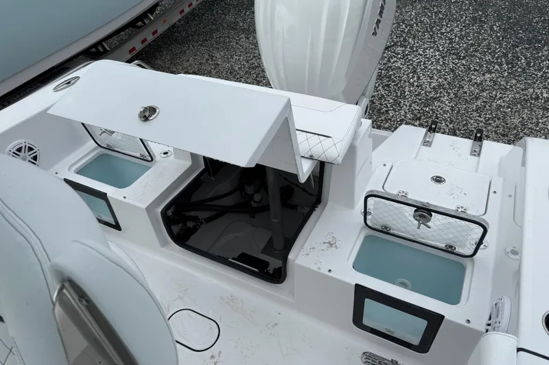 Slide: The Image of 2026 Sportsman Heritage 231 Center Console boat interior with storage compartments and seating. - 5