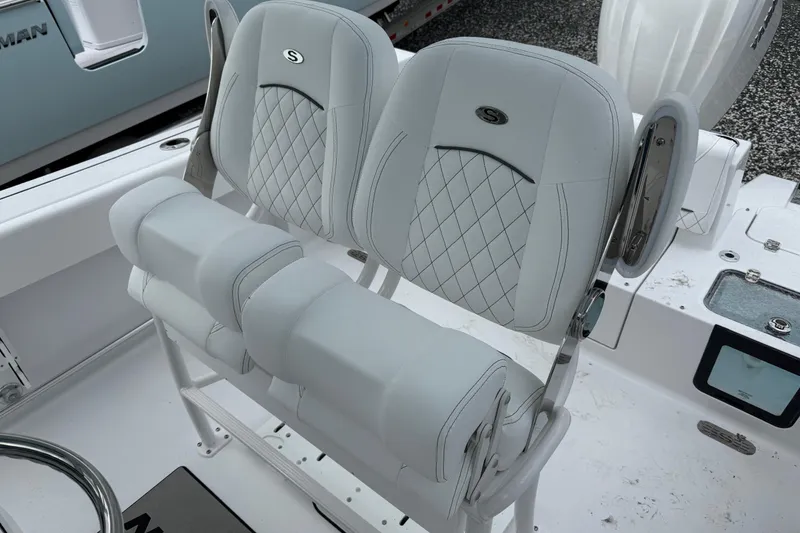 Slide: The Image of 2026 Sportsman Heritage 231 Center Console boat seats with diamond stitching and armrests. - 6