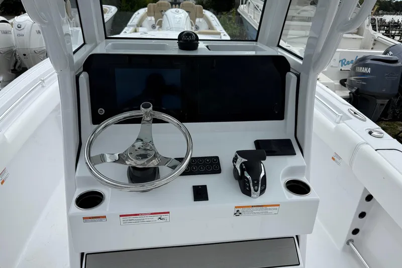 Slide: The Image of 2026 Sportsman Heritage 231 Center Console helm with steering wheel and controls. - 7