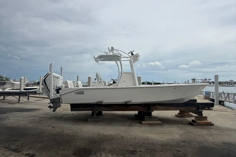 Slide: The Image of 2023 Tides 26 boat on dock, overcast sky, marina background. - 1