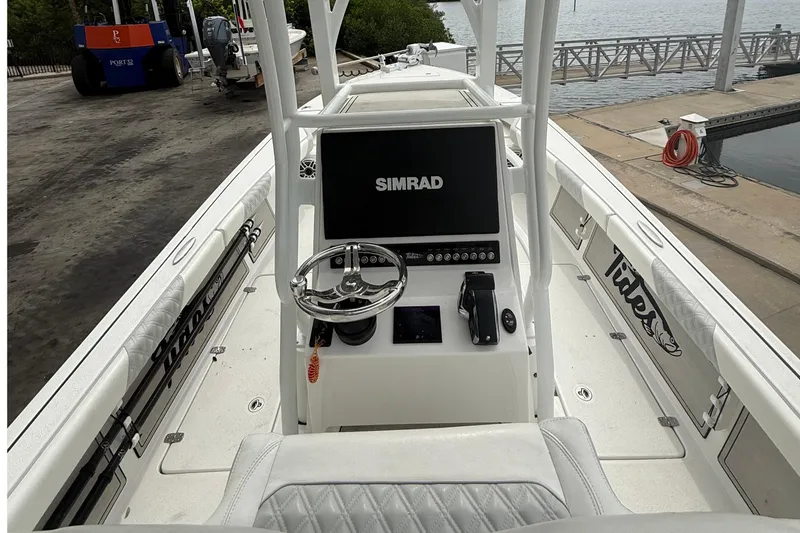 Slide: The Image of 2023 Tides 26 boat dashboard with Simrad display at marina. - 11