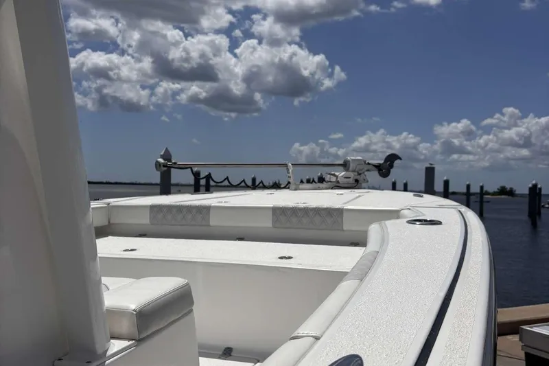 Slide: The Image of 2023 Tides 26 boat on water under cloudy sky, showcasing sleek design. - 12