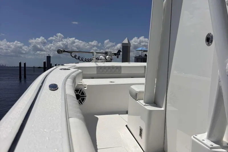 Slide: The Image of 2023 Tides 26 boat deck with seating, ocean view, and clear sky. - 13