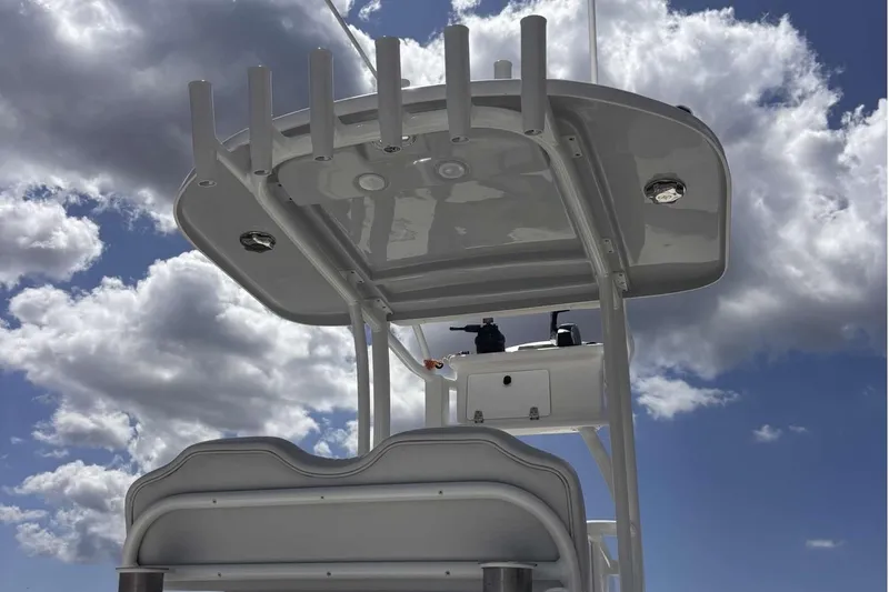 Slide: The Image of 2023 Tides 26 boat with T-top against cloudy sky background. - 14