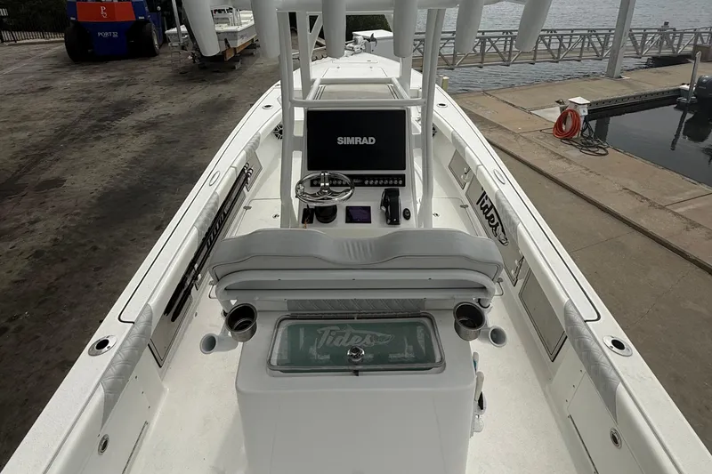 Slide: The Image of 2023 Tides 26 boat interior with Simrad navigation system at dockside. - 16