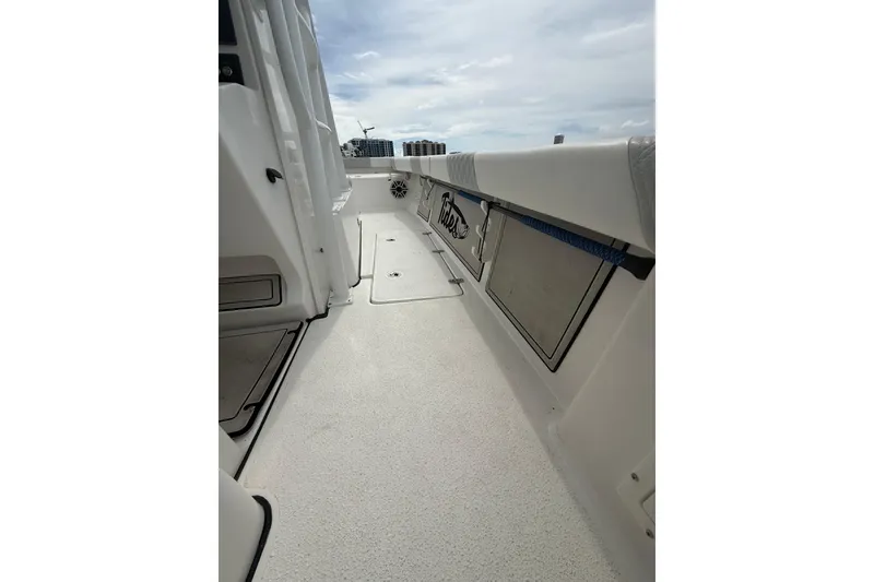 Slide: The Image of 2023 Tides 26 boat deck with storage compartments and sleek design. - 18