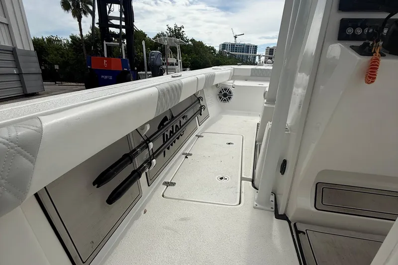 Slide: The Image of 2023 Tides 26 boat interior with rod holders and storage compartments. - 19