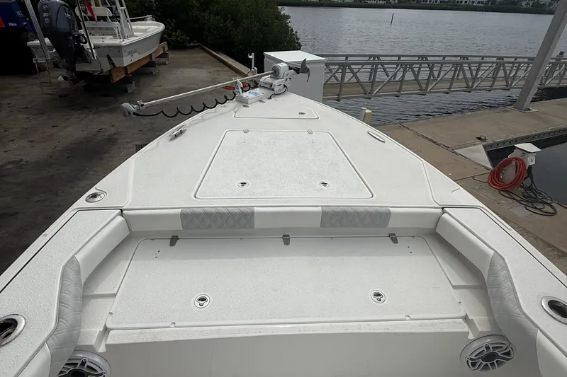 Slide: The Image of 2023 Tides 26 boat at dock, featuring spacious deck and modern design. - 20