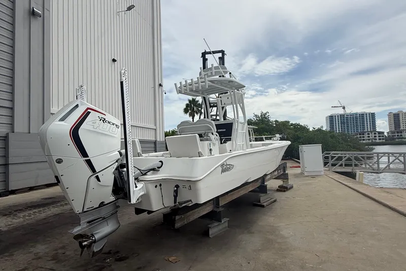Slide: The Image of 2023 Tides 26 boat with powerful engine docked near waterfront buildings. - 24